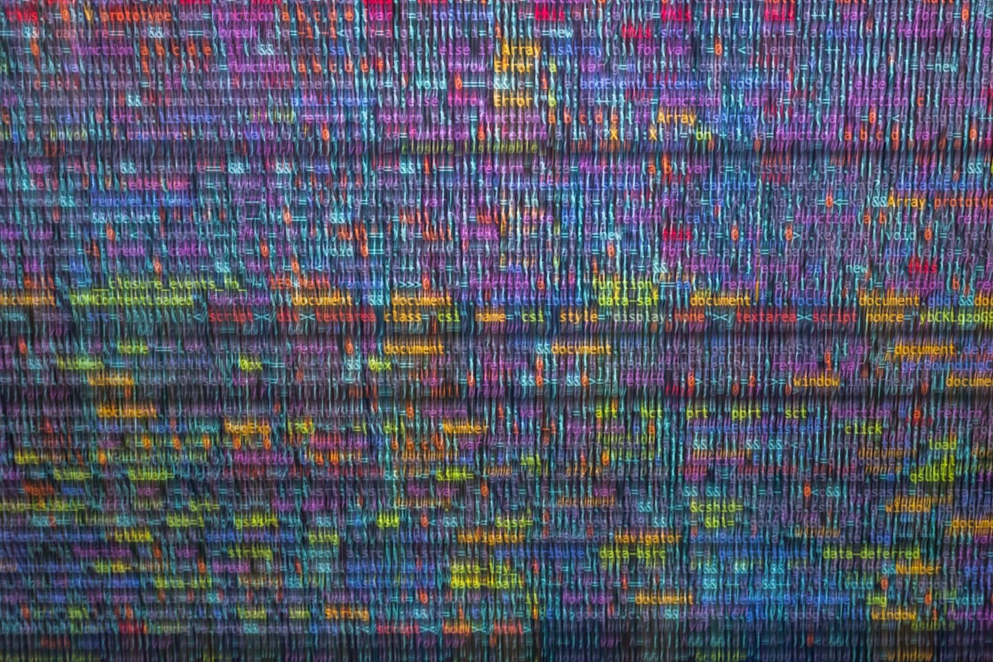 Colorful lines of computer code scroll across a dark screen.